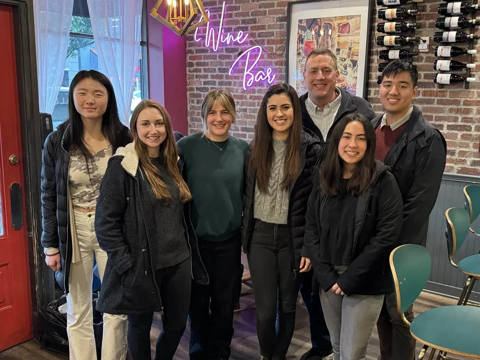 Group of lab members inside a restaurant posing for a group photo