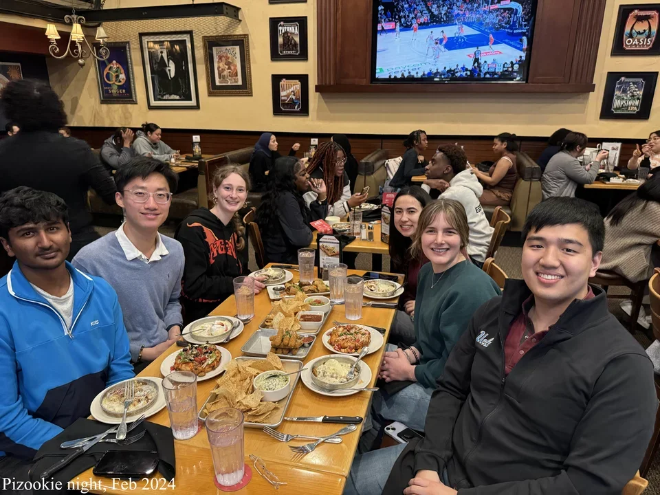 6 students sitting by a rectangle table eating cookies at BJ's