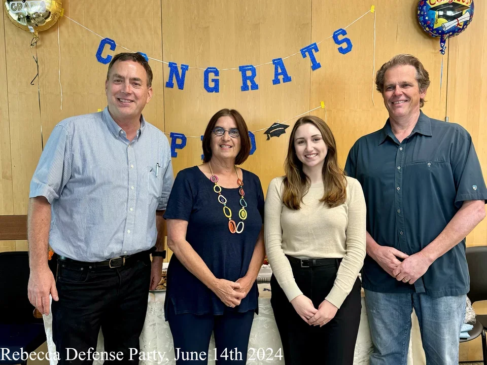 Rebecca standing next to her committee members