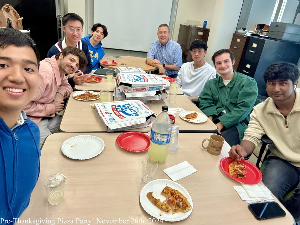 students in the lab eating pizza