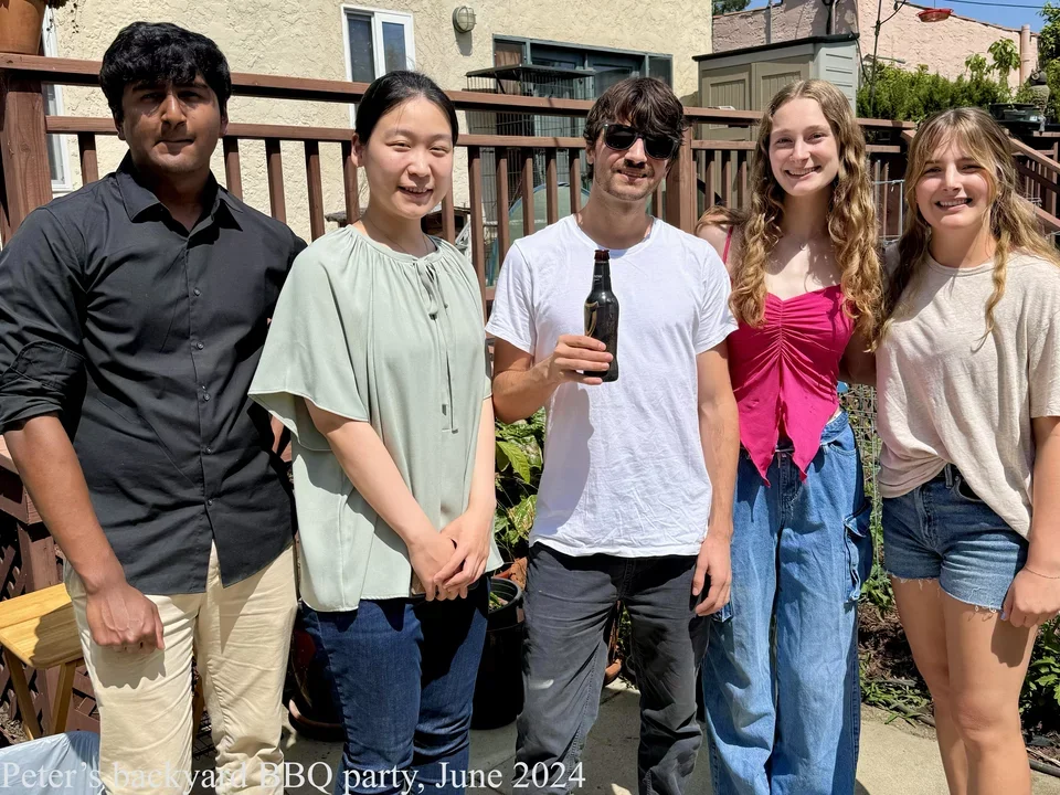 5 students standing outside in backyard