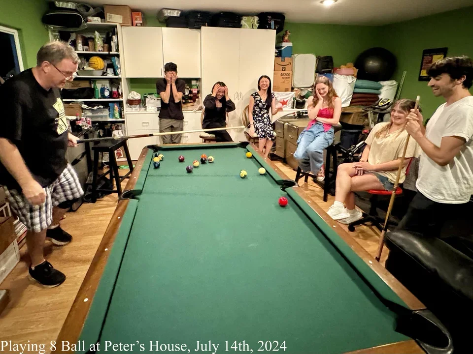 group of students around playing 8 ball