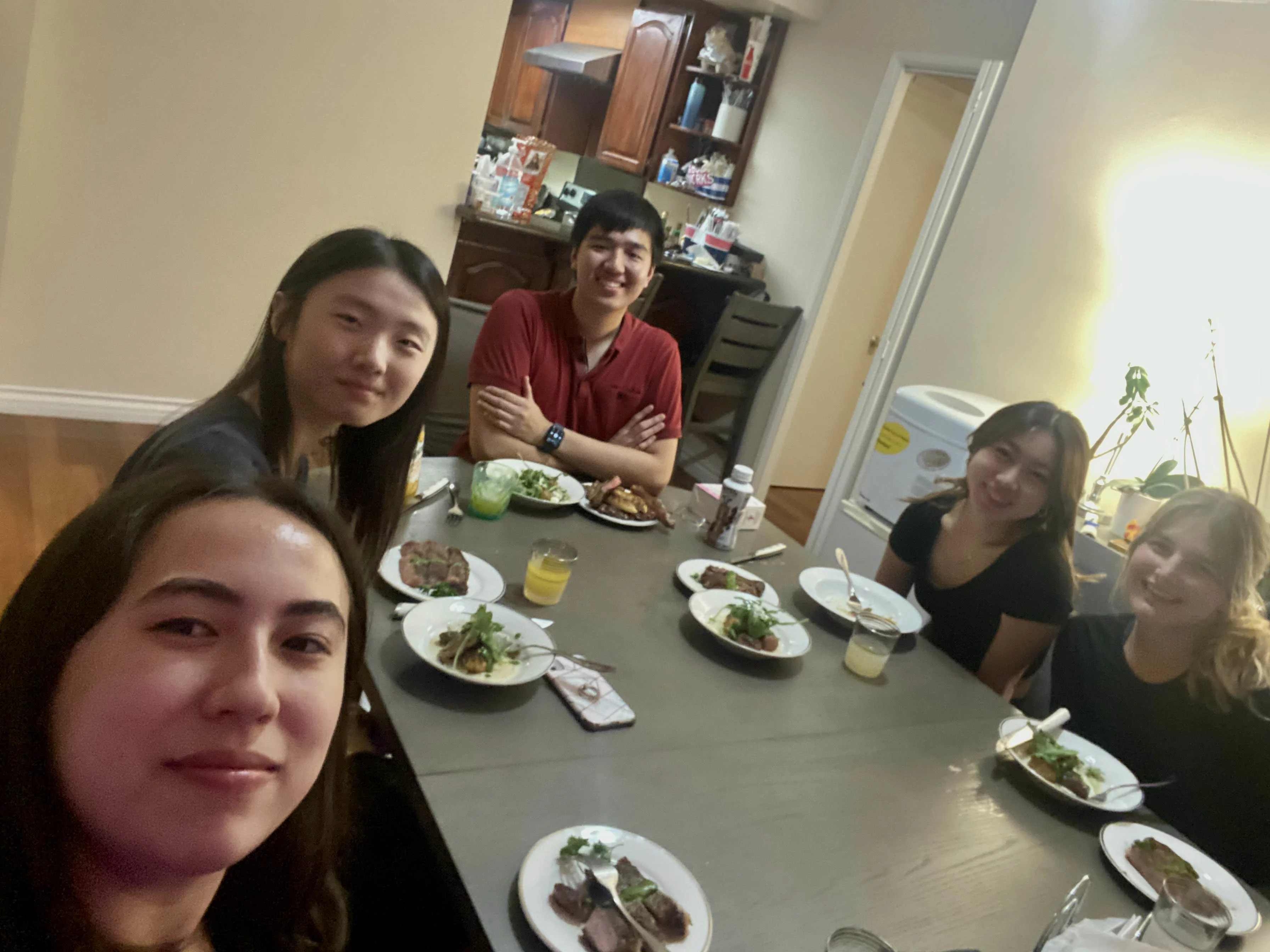 Five undergraduate lab students eating dinner at an apartment.