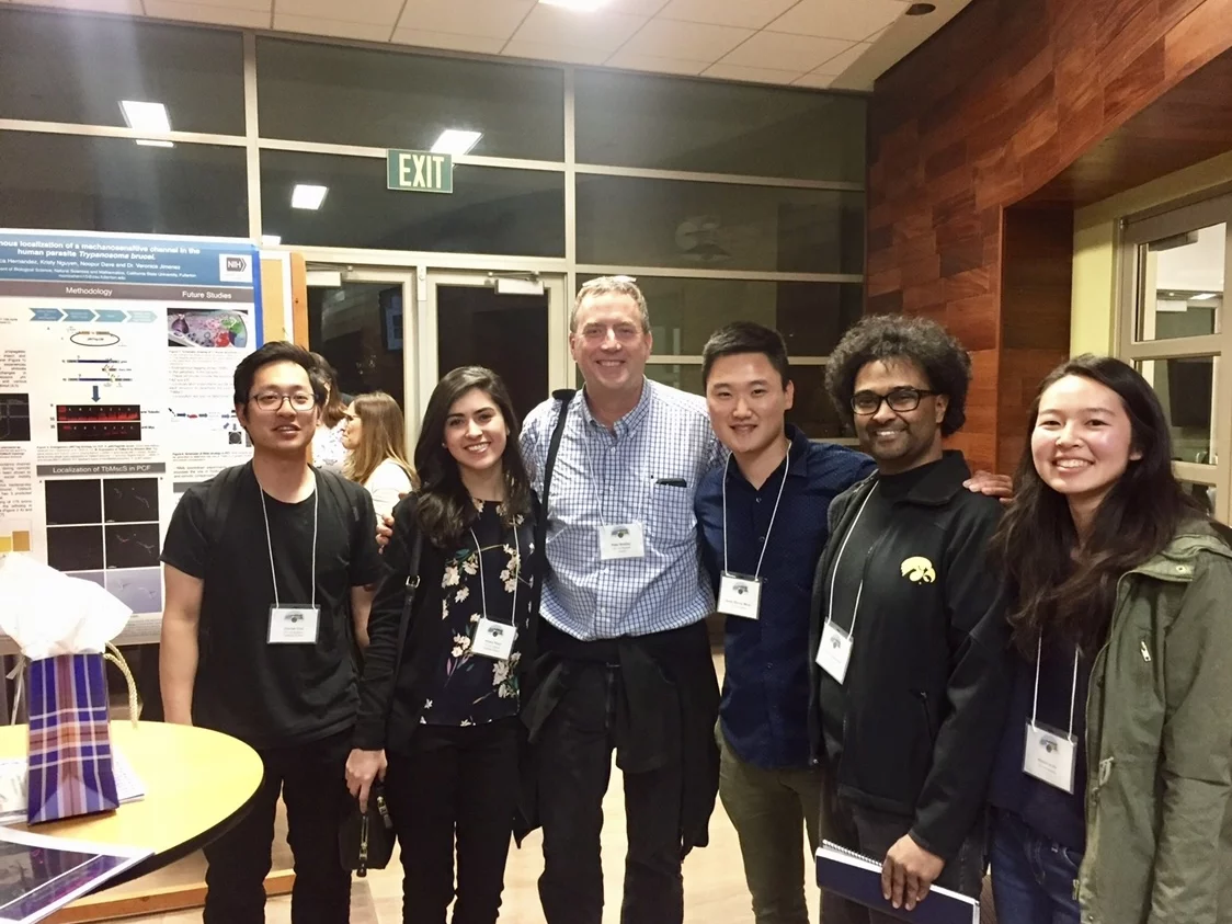 Six lab members are gathering around a table at UC Riverside for the annual Southern California Eukaryotic Symposium conference.