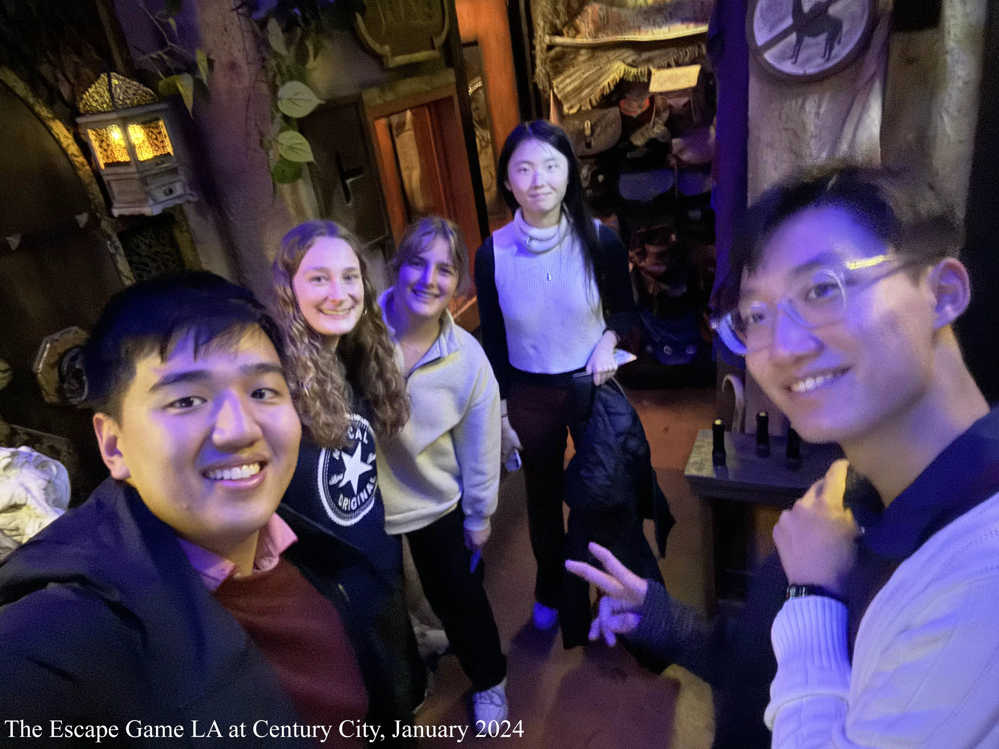 5 students taking a selfie in an escape room